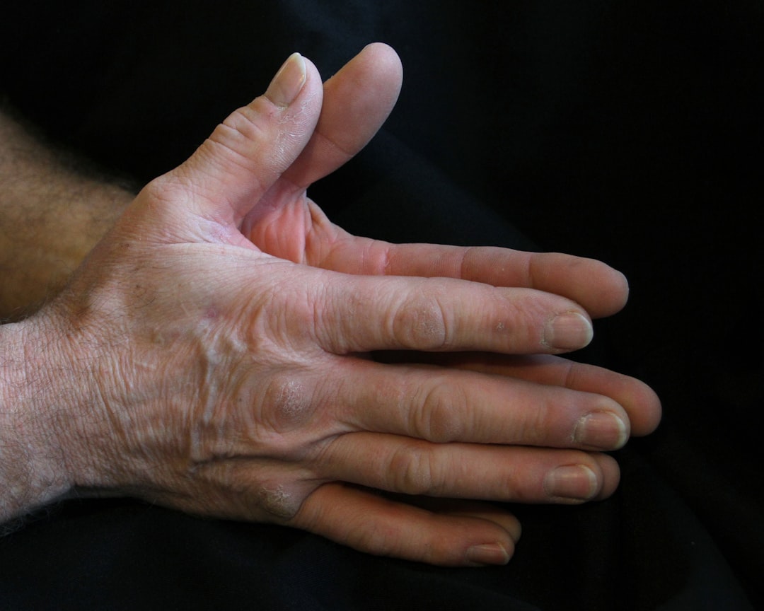 Two hands, one digital and one human, clasped together, representing technological support for recovery.